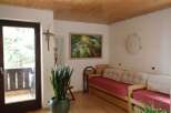 This cozy living space features a warm wooden ceiling and a comfortable daybed, perfect for relaxation.