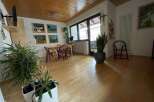 This charming living space features a warm wooden ceiling and flooring, creating a cozy atmosphere.