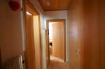 Explore the warm and inviting interior of this property, featuring beautiful wooden doors and paneling throughout.