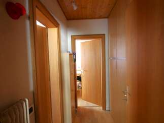 Explore the warm and inviting interior of this property, featuring beautiful wooden doors and paneling throughout.