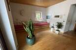 Discover a cozy living space with a warm wooden ceiling and inviting natural light.