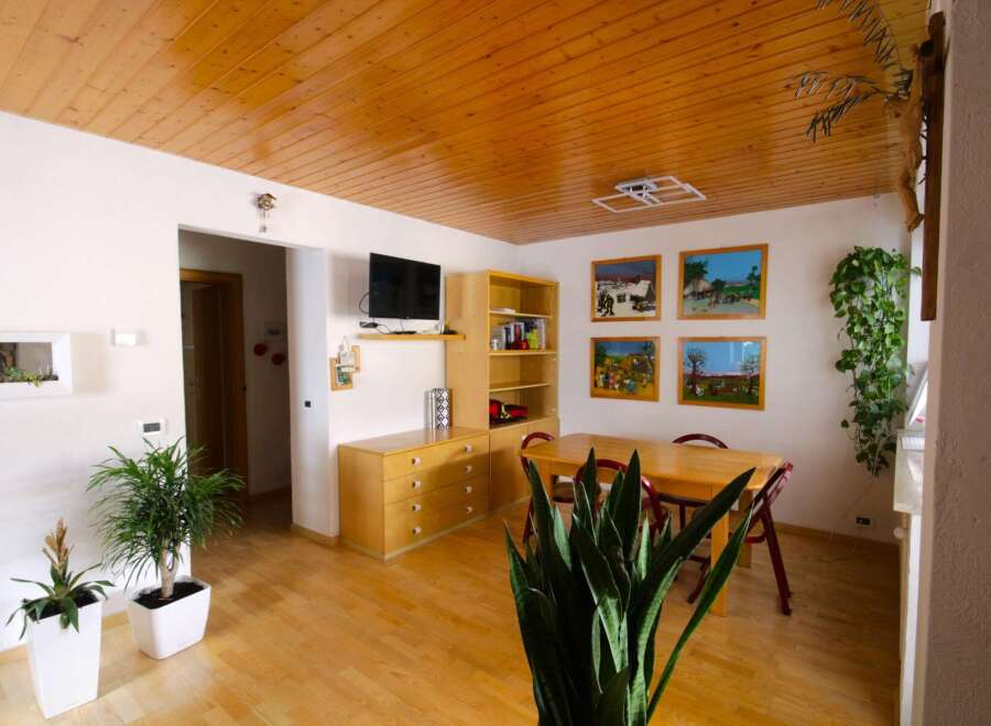 This charming property boasts a warm and inviting atmosphere with its wooden ceiling and flooring.