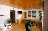 This charming property boasts a warm and inviting atmosphere with its wooden ceiling and flooring.
