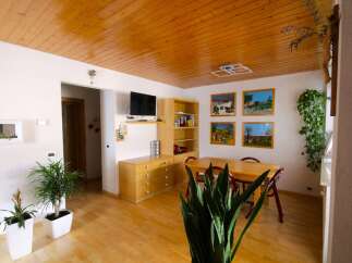 This charming property boasts a warm and inviting atmosphere with its wooden ceiling and flooring.