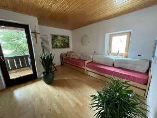 This cozy living space features a warm wooden ceiling and flooring, creating a welcoming atmosphere.
