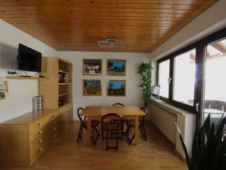 This charming dining area features a warm wooden ceiling and flooring, creating a cozy atmosphere.