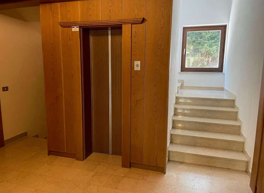 Discover a home with timeless elegance, featuring a classic elevator for easy access to all levels.