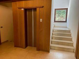 Discover a home with timeless elegance, featuring a classic elevator for easy access to all levels.