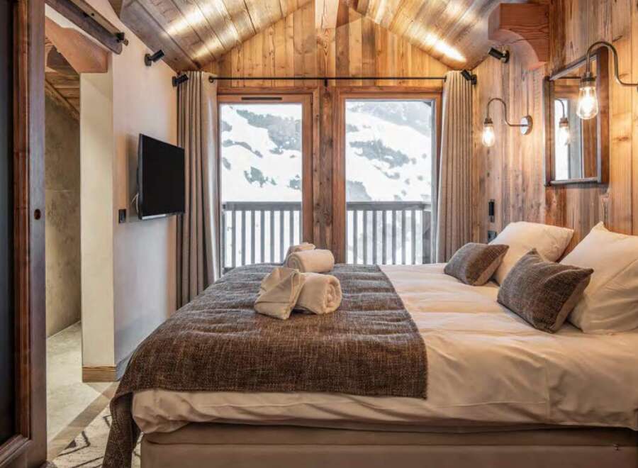 Luxury chalet bedroom with stunning mountain views.