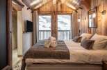 Luxury chalet bedroom with stunning mountain views.