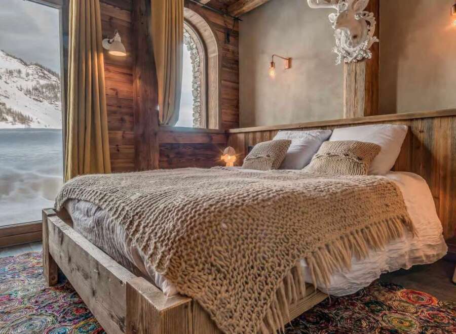 Cozy chalet bedroom with stunning mountain views.