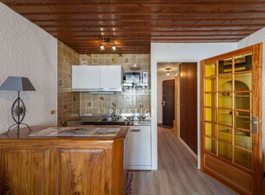 Discover this charming property featuring a cozy kitchen with wooden cabinets and a microwave.