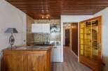 Discover this charming property featuring a cozy kitchen with wooden cabinets and a microwave.