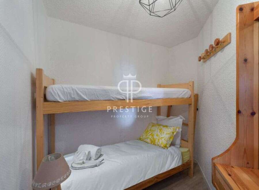 Cozy bunk beds offer a comfortable sleeping arrangement, perfect for families or groups.