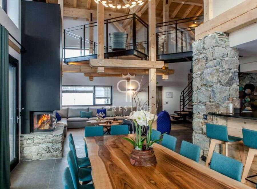 Experience luxury living in this stunning property, featuring a modern fireplace and a spacious dining area perfect for entertaining.