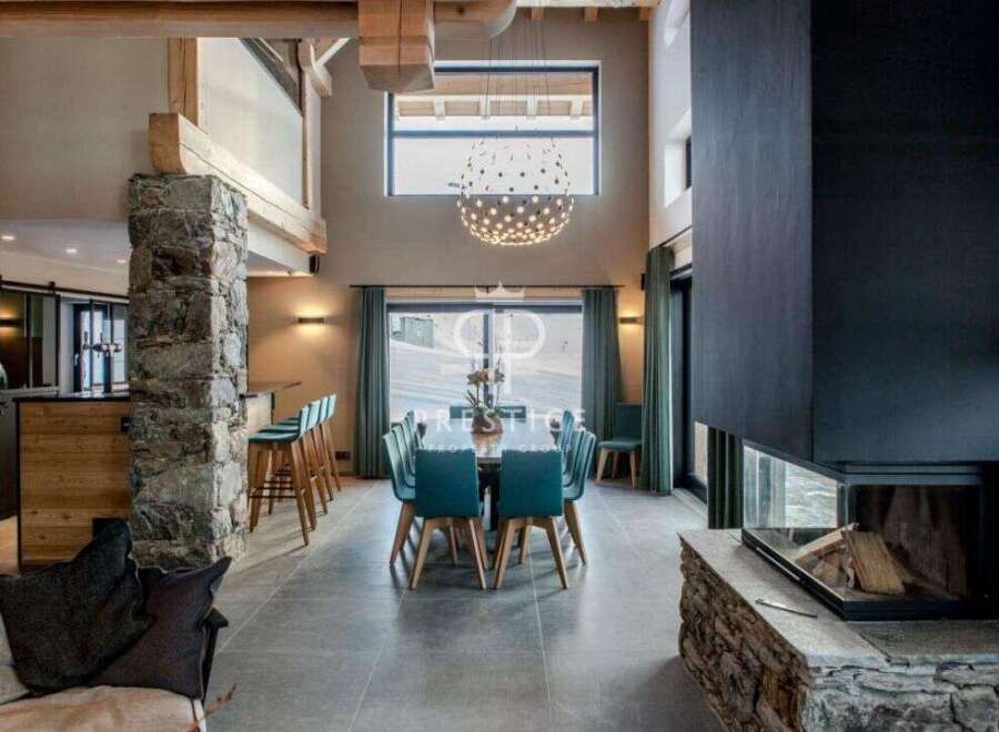 Experience luxury living in this stunning property, featuring a modern fireplace and a spacious dining area perfect for entertaining.