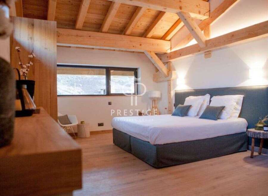 Experience luxury in this stunning bedroom featuring a cozy bed with plush pillows and a stylish headboard.