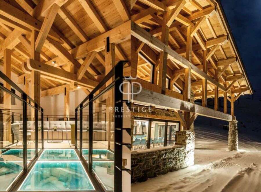Experience luxury living in this stunning property, showcasing exquisite wooden architecture and a unique glass floor feature.