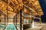 Experience luxury living in this stunning property, showcasing exquisite wooden architecture and a unique glass floor feature.