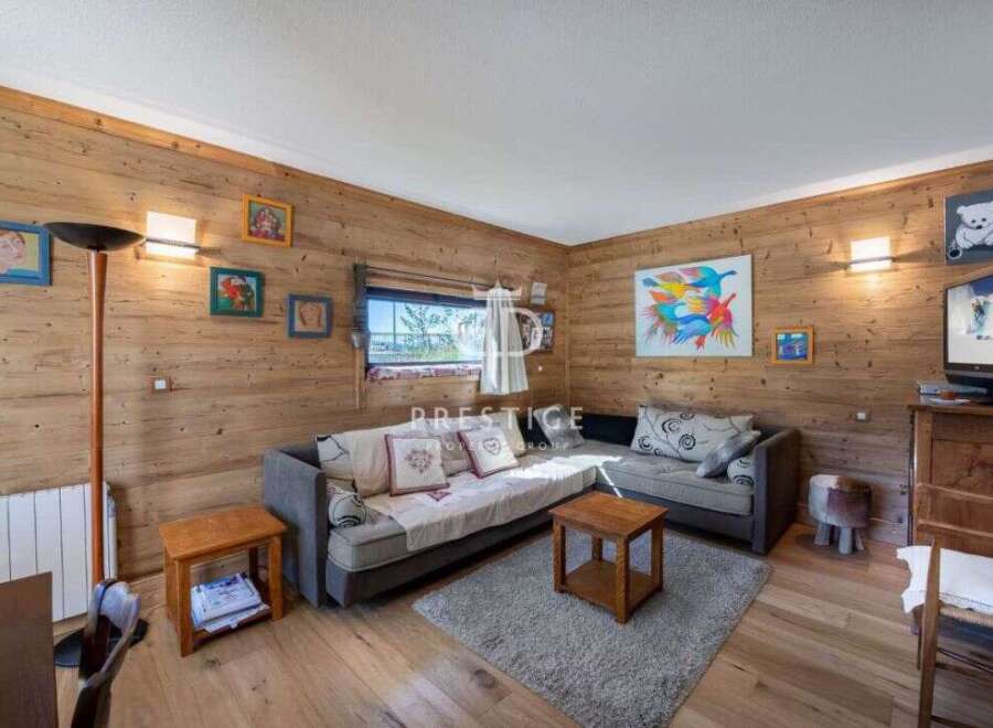 Cozy living space with wooden walls and floors, creating a warm and inviting atmosphere.