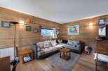 Cozy living space with wooden walls and floors, creating a warm and inviting atmosphere.
