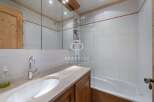 Discover a beautifully designed bathroom featuring a sleek sink and a relaxing bathtub.