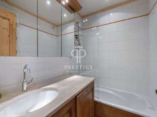Discover a beautifully designed bathroom featuring a sleek sink and a relaxing bathtub.