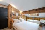 Discover luxury living in this stunning bedroom featuring a unique wooden design.