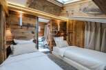 Experience luxury in this stunning bedroom featuring exquisite wooden paneling and a cozy ambiance.