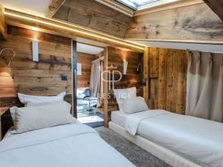 Experience luxury in this stunning bedroom featuring exquisite wooden paneling and a cozy ambiance.