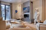 Experience luxury living in this stunning property, featuring a modern fireplace and a unique polar bear statue.
