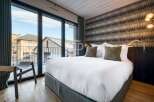 Experience luxury in this stunning bedroom with breathtaking views.