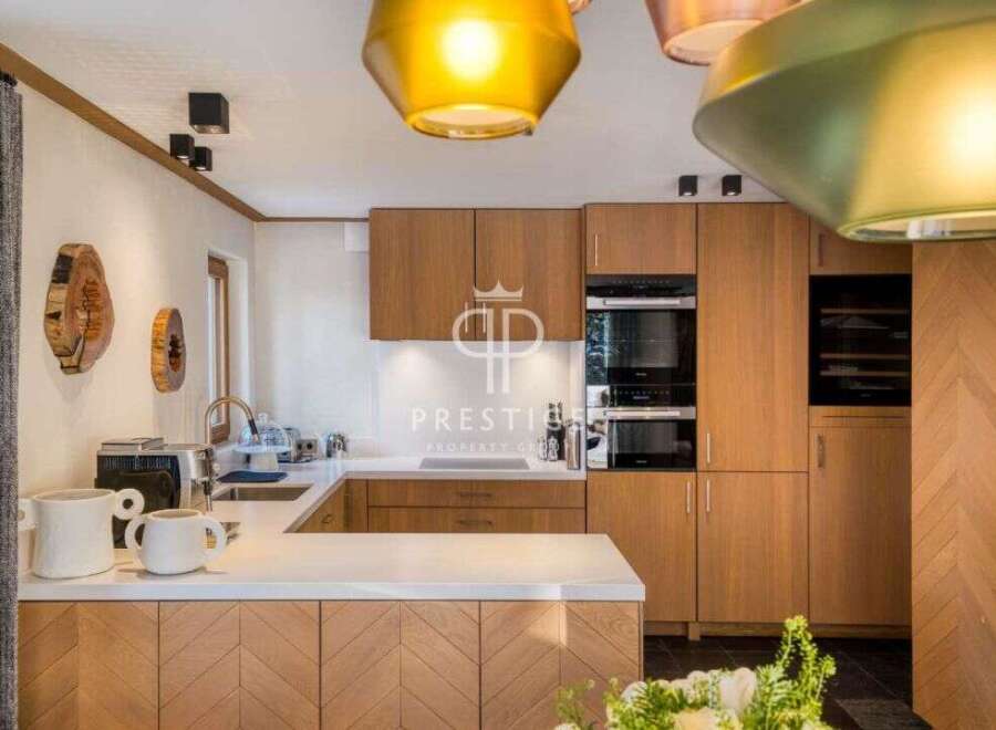 This stunning kitchen boasts custom cabinetry and high-end appliances, perfect for culinary enthusiasts.