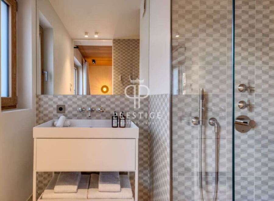 Discover a modern bathroom design featuring a sleek white vanity and a stylish glass-enclosed shower.