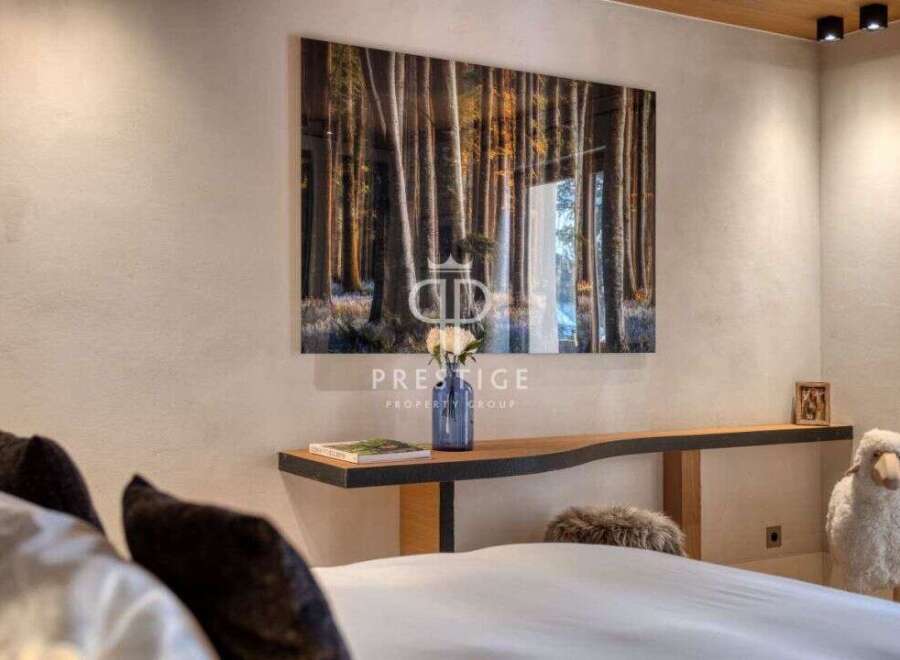 Experience tranquility in this stunning bedroom, featuring a captivating forest artwork that brings the outdoors in.
