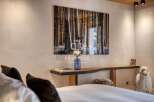 Experience tranquility in this stunning bedroom, featuring a captivating forest artwork that brings the outdoors in.