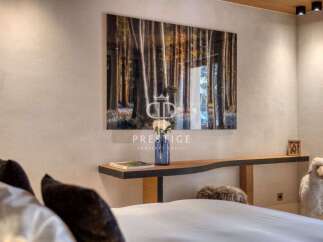 Experience tranquility in this stunning bedroom, featuring a captivating forest artwork that brings the outdoors in.