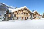 Experience the ultimate winter getaway in these stunning chalets nestled in a snowy landscape.