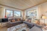Experience the charm of this cozy living room, perfect for relaxing after a day on the slopes.