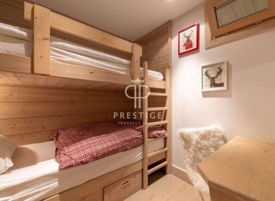 Cozy bunk beds in a rustic-style bedroom.