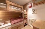 Cozy bunk beds in a rustic-style bedroom.