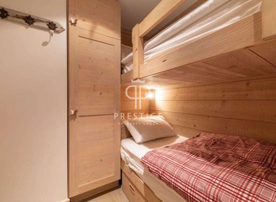 Discover a cozy bedroom featuring a charming bunk bed, perfect for accommodating guests or family.