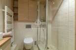 Discover a luxurious bathroom featuring a sleek glass shower enclosure.