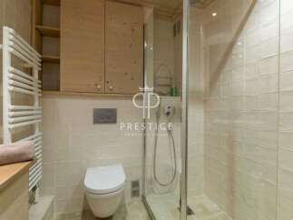 Discover a luxurious bathroom featuring a sleek glass shower enclosure.