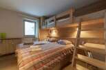 Discover a cozy bedroom with a unique bunk bed setup, perfect for family or group stays.