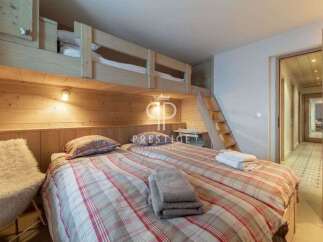 Discover the charm of this cozy bedroom featuring a unique bunk bed design, perfect for families or groups.