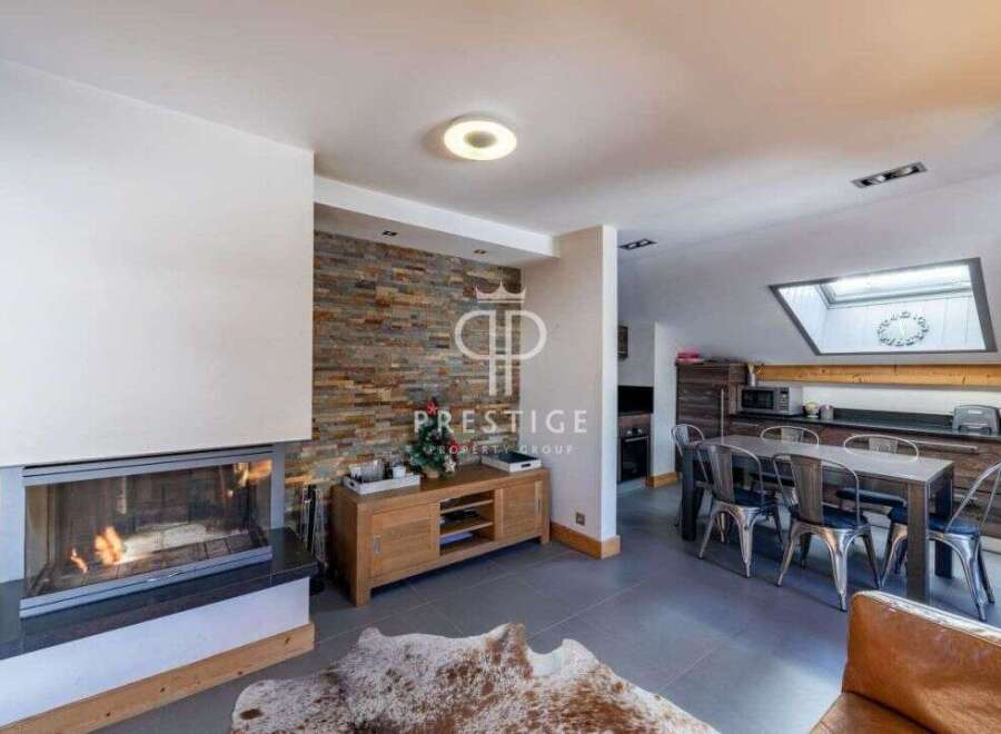 Discover luxury living in this stunning property, featuring a cozy fireplace and a modern kitchen.