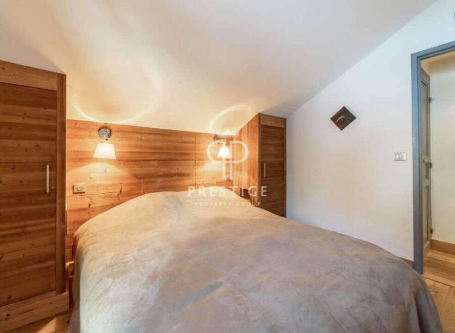 Discover a cozy bedroom retreat with a rustic wooden accent wall.