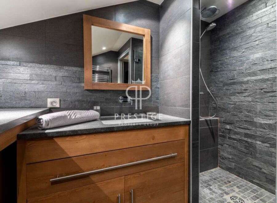 Discover a luxurious bathroom featuring a sleek design with a modern shower and stylish vanity.