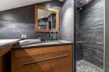Discover a luxurious bathroom featuring a sleek design with a modern shower and stylish vanity.